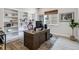 Spacious home office with built-in bookshelves, large wooden desk, and decorative rug at 1581 Diamond Hill Ct, Castle Rock, CO 80104