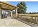 Inviting outdoor back deck featuring stone columns and overlooking the manicured golf course at 23738 E Clifton Pl, Aurora, CO 80016