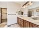Well-appointed bathroom with dual sinks, wood cabinetry, and a separate tiled shower, providing convenience at 23738 E Clifton Pl, Aurora, CO 80016