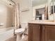 Bright bathroom featuring a shower-tub combination, tiled walls, and a wood vanity at 23738 E Clifton Pl, Aurora, CO 80016