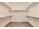Walk-in closet with multiple shelves and carpeted flooring offering ample storage space at 23738 E Clifton Pl, Aurora, CO 80016