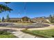 Stately clubhouse entrance featuring a circular driveway, stone accents and well-maintained landscaping at 23738 E Clifton Pl, Aurora, CO 80016