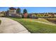 Community entrance with a sign, beautiful landscaping, and a pathway to a walking trail at 23738 E Clifton Pl, Aurora, CO 80016