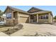 Charming home with a two-car garage, stone accents, and a covered front porch at 23738 E Clifton Pl, Aurora, CO 80016