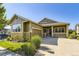 Charming ranch-style home with stone accents, an attached garage, and a well-maintained front lawn at 23738 E Clifton Pl, Aurora, CO 80016