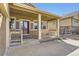 Covered front porch with classic railings and columns, offering a welcoming entrance at 23738 E Clifton Pl, Aurora, CO 80016