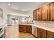 Open kitchen featuring wood cabinets, stainless steel appliances, and hardwood flooring with a view to the outdoor deck at 23738 E Clifton Pl, Aurora, CO 80016