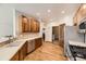 Modern kitchen with stainless steel appliances, wood cabinets, and an open layout at 23738 E Clifton Pl, Aurora, CO 80016