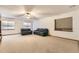 Spacious living room with plush carpeting, a ceiling fan, and natural light from two large windows at 23738 E Clifton Pl, Aurora, CO 80016