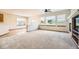 Bright living room featuring large windows, neutral carpet, and open layout for modern comfort at 23738 E Clifton Pl, Aurora, CO 80016