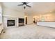 Spacious living room with a cozy fireplace, neutral carpet, and an open layout perfect for gatherings at 23738 E Clifton Pl, Aurora, CO 80016