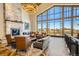 Stylish lounge area with a stone fireplace, large windows, and comfortable seating for relaxation and socializing at 23738 E Clifton Pl, Aurora, CO 80016