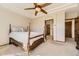 Bright main bedroom with a tray ceiling, ceiling fan, and ensuite bathroom at 23738 E Clifton Pl, Aurora, CO 80016