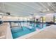Bright indoor pool with clear blue water and marked lanes at 23738 E Clifton Pl, Aurora, CO 80016