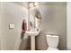 Charming powder room with pedestal sink and decorative mirror, perfect for guests at 23738 E Clifton Pl, Aurora, CO 80016