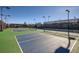 Multiple well-lit tennis courts with professional surfaces and fencing at 23738 E Clifton Pl, Aurora, CO 80016