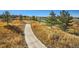 Picturesque walking path leading to a golf course and ponds with trees in a well-maintained community at 23738 E Clifton Pl, Aurora, CO 80016