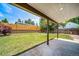 Well-maintained backyard featuring a lawn and a covered patio area on a sunny day at 4064 S Olathe Ct, Aurora, CO 80013