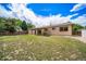 Lush backyard features a well-manicured lawn, inviting patio area, and mature trees for privacy at 4064 S Olathe Ct, Aurora, CO 80013
