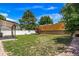 Spacious backyard with a lush lawn, privacy fence, and a covered patio at 4064 S Olathe Ct, Aurora, CO 80013