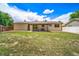 Large backyard with a green lawn, a covered patio, and mature trees, offering ample space at 4064 S Olathe Ct, Aurora, CO 80013