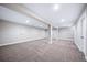 Bright basement area with a large open space, neutral walls, and carpet flooring at 4064 S Olathe Ct, Aurora, CO 80013