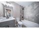 Bathroom features gray vanity, a bathtub with tiled walls, and modern fixtures at 4064 S Olathe Ct, Aurora, CO 80013