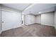Basement bedroom with sliding closet doors and access to ensuite bathroom at 4064 S Olathe Ct, Aurora, CO 80013
