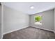 Bedroom featuring neutral carpeting and a window with a tree-lined view at 4064 S Olathe Ct, Aurora, CO 80013