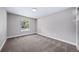 A bright bedroom with a window providing natural light and neutral-toned walls at 4064 S Olathe Ct, Aurora, CO 80013