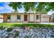 Charming single-story home with a manicured lawn and attractive stone landscaping at 4064 S Olathe Ct, Aurora, CO 80013