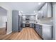 Updated kitchen features stainless steel appliances, gray cabinets, and light wood flooring at 4064 S Olathe Ct, Aurora, CO 80013