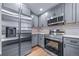 Updated kitchen features stainless steel appliances and light gray cabinets at 4064 S Olathe Ct, Aurora, CO 80013