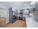 Updated kitchen features stainless steel appliances, gray cabinets, and quartz countertops at 4064 S Olathe Ct, Aurora, CO 80013