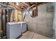 Basement laundry area showcasing a washer and dryer next to the concrete wall at 4064 S Olathe Ct, Aurora, CO 80013