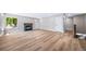Open living room showcases new flooring, a fireplace, and staircase to the basement at 4064 S Olathe Ct, Aurora, CO 80013