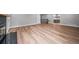 Open-concept living area featuring a fireplace, updated flooring, and a view of the kitchen at 4064 S Olathe Ct, Aurora, CO 80013