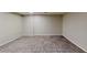 Finished basement area with neutral-toned walls and vinyl flooring at 1050 S Monaco Pkwy # 38, Denver, CO 80224