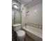 Cozy bathroom with white tiled walls and tub at 1050 S Monaco Pkwy # 38, Denver, CO 80224