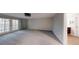 Bright bedroom with carpet, french doors leading to a balcony, and an ensuite bathroom at 1050 S Monaco Pkwy # 38, Denver, CO 80224
