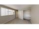 Bright bedroom featuring a large window, built-in shelves, and a closet at 1050 S Monaco Pkwy # 38, Denver, CO 80224