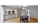 Charming dining room features hardwood floors, a modern light fixture, and an open view to the kitchen at 1050 S Monaco Pkwy # 38, Denver, CO 80224