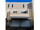 Exterior view of home featuring a two-car garage and upper level balcony at 1050 S Monaco Pkwy # 38, Denver, CO 80224