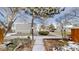Exterior view of a well-maintained townhome community with mature trees at 1050 S Monaco Pkwy # 38, Denver, CO 80224