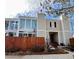 Two-story exterior elevation with well-maintained landscaping, light beige walls, and brown fence at 1050 S Monaco Pkwy # 38, Denver, CO 80224