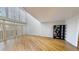 Spacious living room featuring hardwood floors, a high ceiling, and large windows for ample natural light at 1050 S Monaco Pkwy # 38, Denver, CO 80224