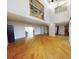 Spacious living room with hardwood floors, large windows, and high ceilings at 1050 S Monaco Pkwy # 38, Denver, CO 80224