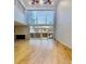 Bright living room with a fireplace, beautiful hardwood floors, and large windows with access to the outdoors at 1050 S Monaco Pkwy # 38, Denver, CO 80224