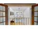 Open loft with railings overlooking the living room below at 1050 S Monaco Pkwy # 38, Denver, CO 80224