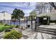 Community pool enclosed by a black metal fence and surrounded by landscaping at 1050 S Monaco Pkwy # 38, Denver, CO 80224